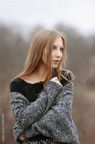 Portrait of a beautiful young girl in sweater close-up © sun0is