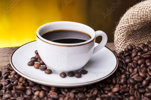 Cup of hot coffee against grunge background