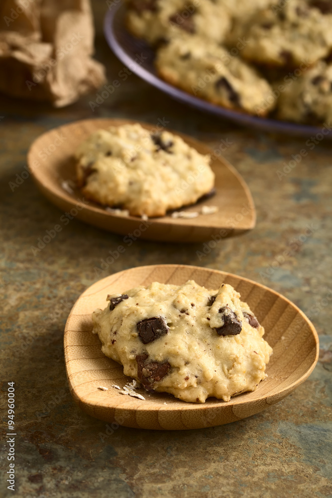 Homemade oatmeal and chocolate cookie on small bamboo plates, photographed with natural light (Selective Focus, Focus on the front of the first cookie) Homemade oatmeal and chocolate cookie on small bamboo plates, photographed with natural light (Selective Focus, Focus on the front of the first cookie)