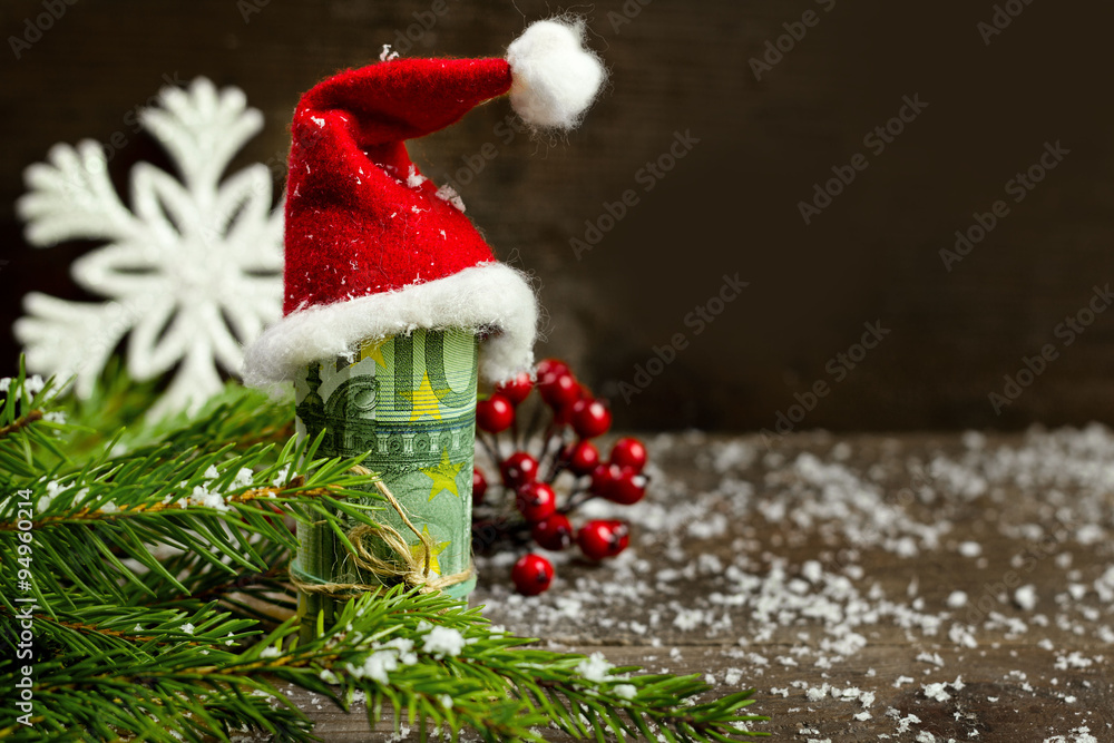 Gift money with red ribbon and Santa cap