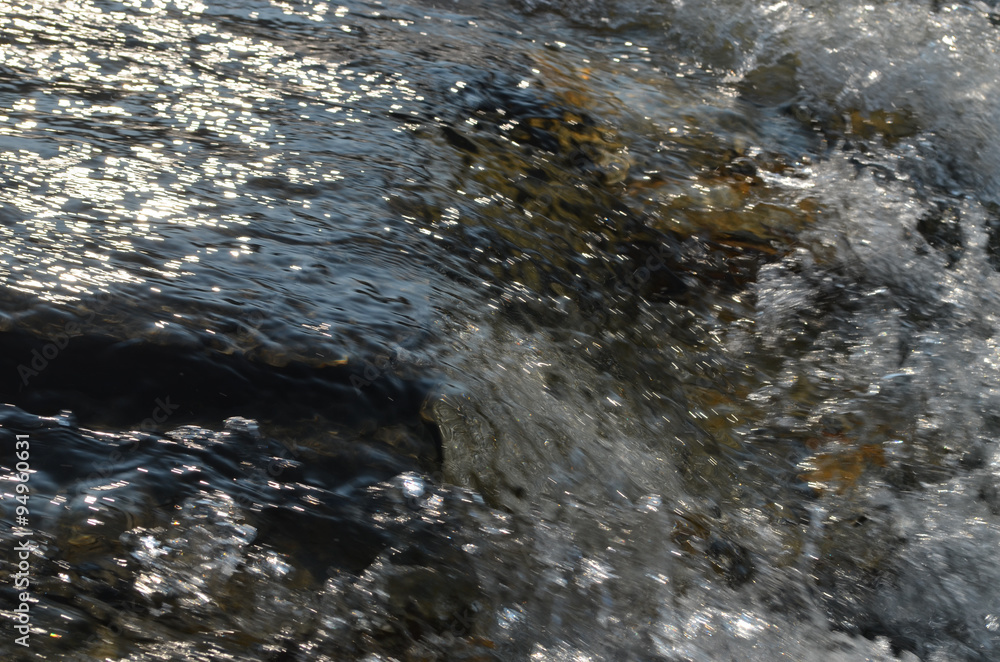 Water flowing over a rock in a river, Abisko, Swedish Lapland