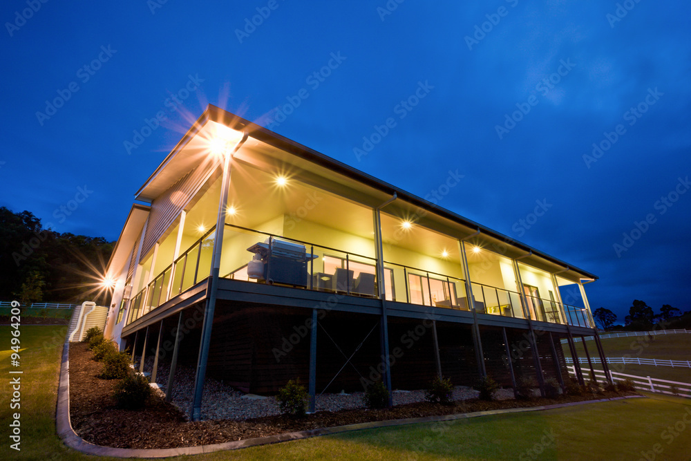 Exterior of lit contemporary house at dusk