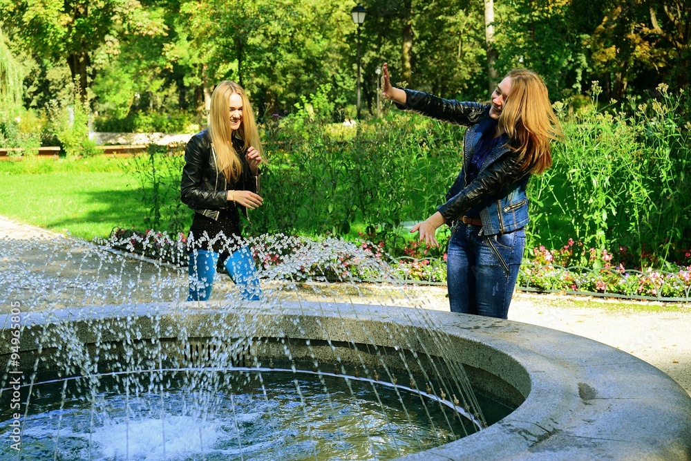 Two girls in Vilnius town Bernardinu garden on autumn