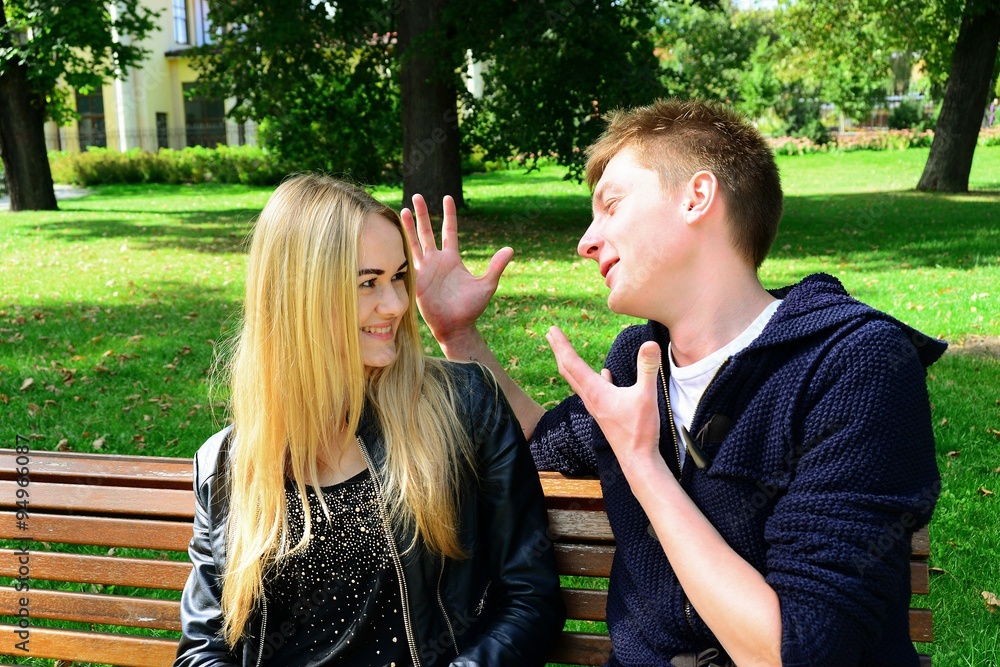 Young couple in Vilnius town Bernardinu garden on autumn