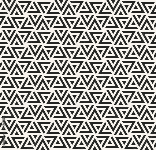 monochrome dense vector pattern of triangles.