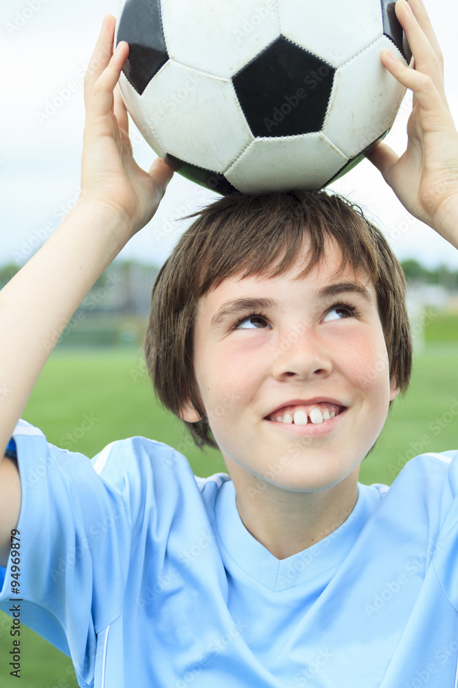 Young soccer player with ball on the field Young soccer player with ball on the field