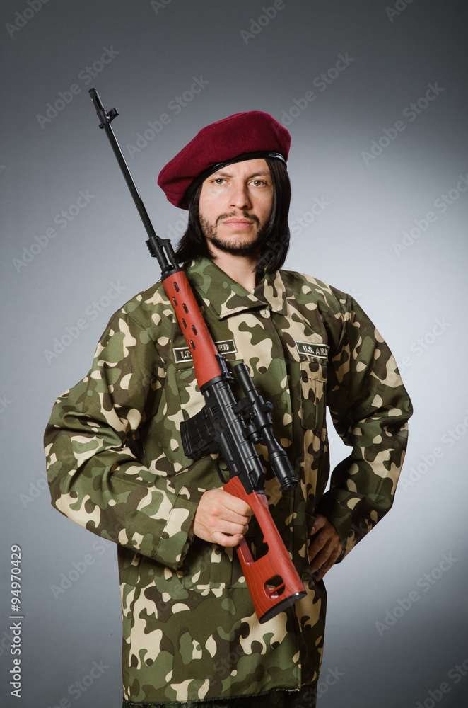 Soldier with handgun against gray Soldier with handgun against gray