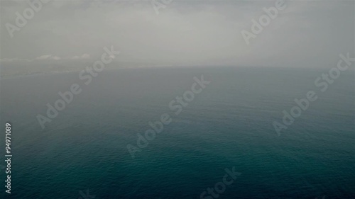Aerial shot birds eye view of a isolated sailboat in the sea water