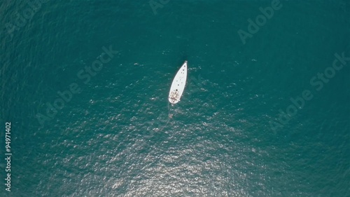Aerial shot birds eye view of a isolated sailboat in the sea water