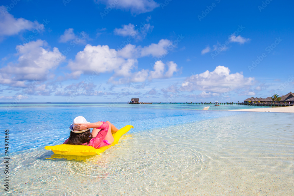 Young happy woman relaxing with air mattress on the beach Young happy woman relaxing with air mattress on the beach