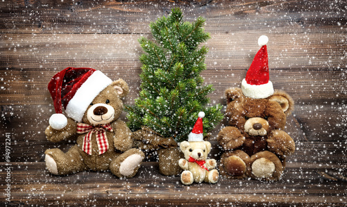 Christmas decoration with funny toys Teddy Bear family in snow