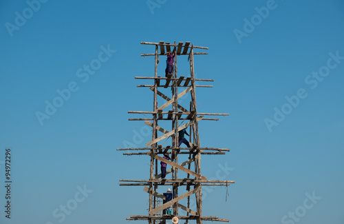 Construction workers on wooden scaffolding