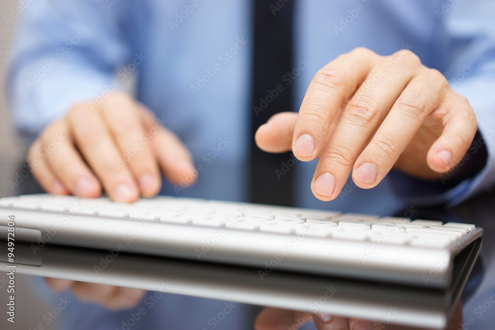 Closeup of businessman typing on modern computer keyboard Closeup of businessman typing on modern computer keyboard