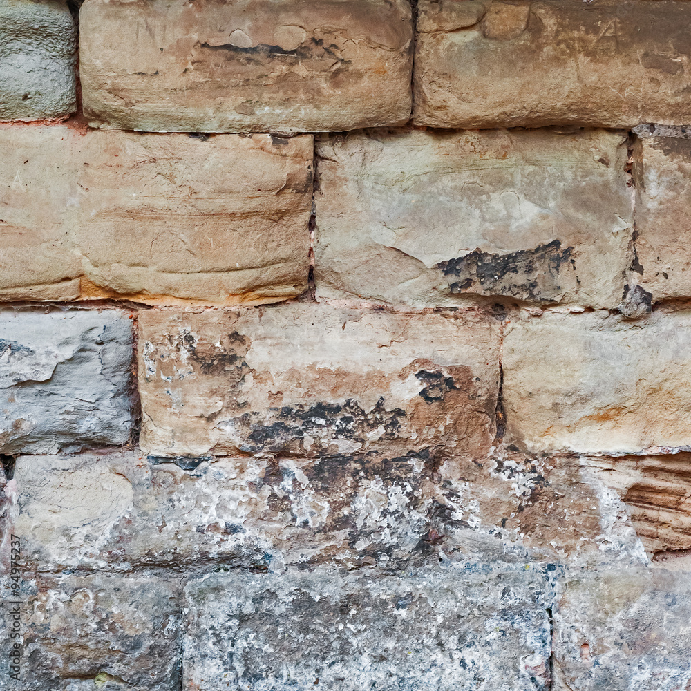 Limestone medieval wall of stone blocks texture background surface empty square closeup Limestone medieval wall of stone blocks texture background surface empty square closeup