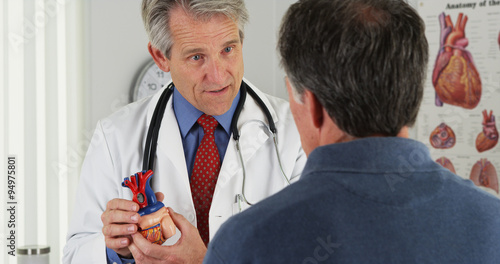 Wall Mural Doctor explaining heart to elderly patient
