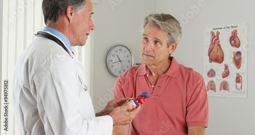 Doctor explaining heart to elderly patient