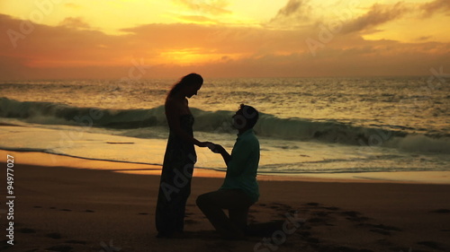Man Proposing To Woman Sunset-Lit Beach