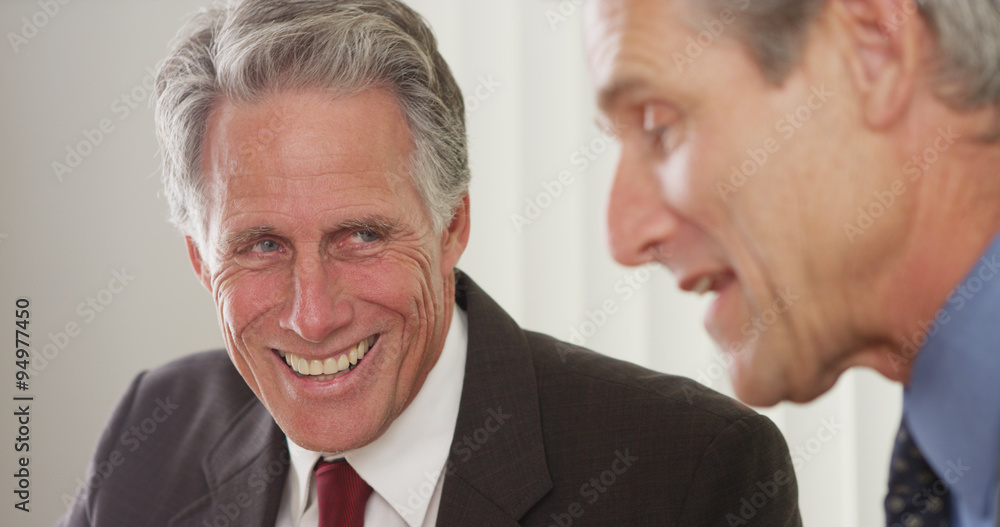 Senior businessmen talking and laughing in the office Senior businessmen talking and laughing in the office