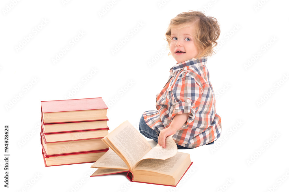 baby boy sitting near pile of books baby boy sitting near pile of books