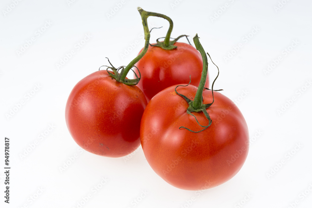 Organic Roma tomatoes on white background.