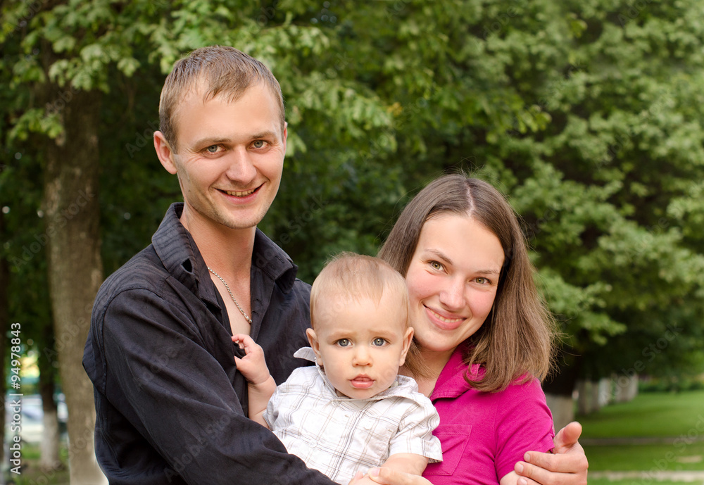 young happy family in summer outdoors young happy family in summer outdoors