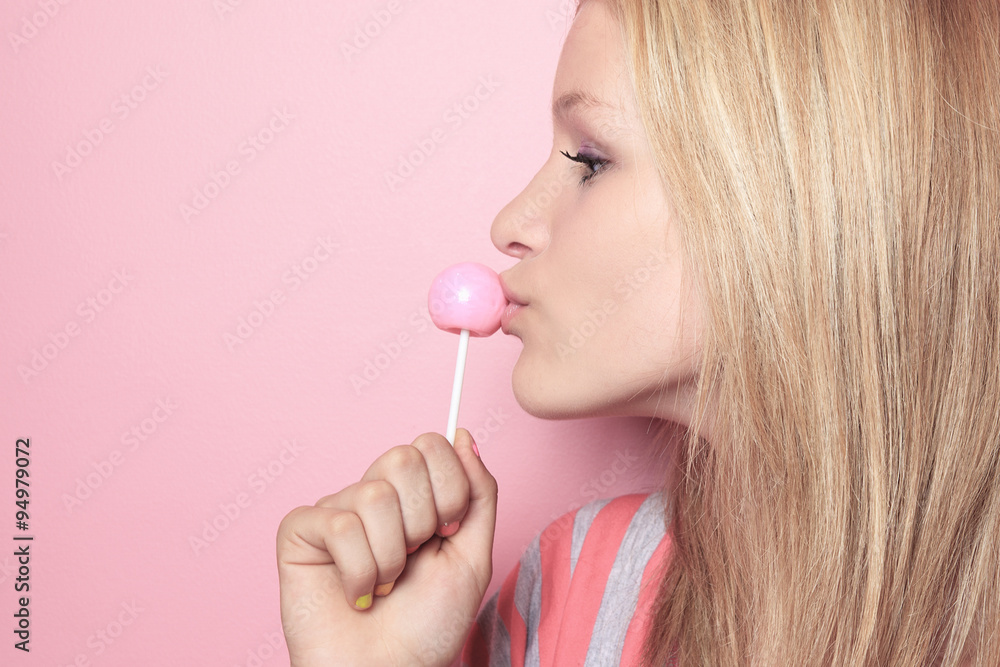 Fototapeta premium girl with lollipop on her bedroom