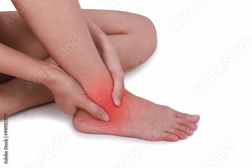 Close up suffering male pain in ankle isolated white background. © jayzynism