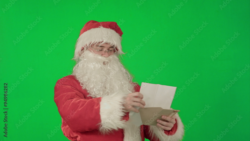 Santa Claus reading letters from children on a Green Screen Chrome Key Santa Claus reading letters from children on a Green Screen Chrome Key