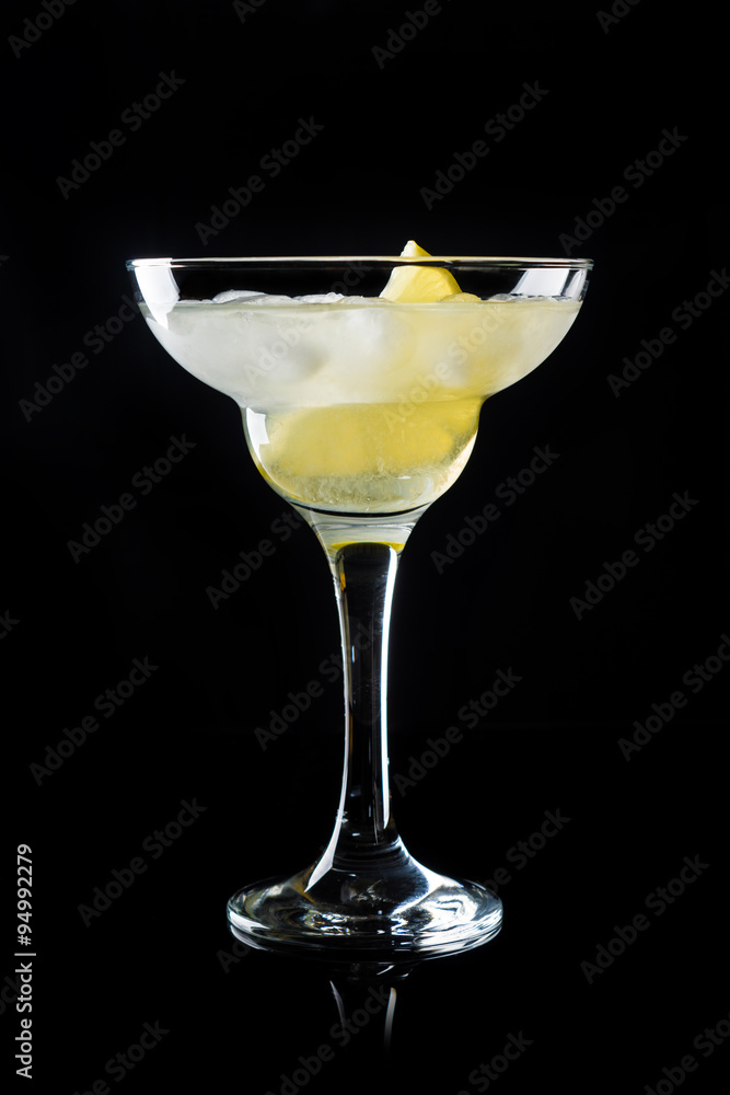 Cocktail margarita with lemon on black background