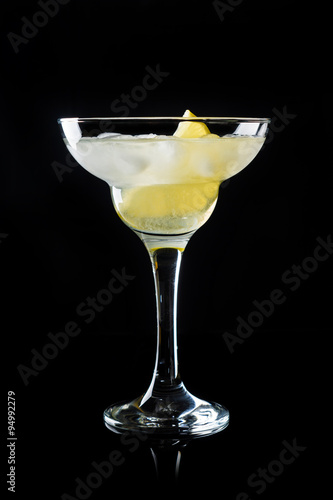 Cocktail margarita with lemon on black background