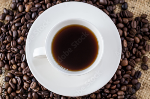 White mug of coffee and saucer