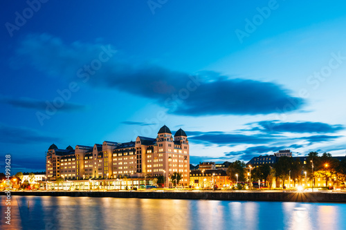 Photography Summer evening view of the house on the citys waterfront, illumi