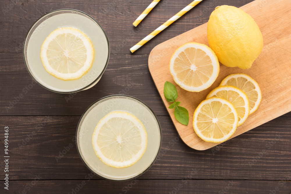 lemonade with fresh slice lemon on wooden background lemonade with fresh slice lemon on wooden background