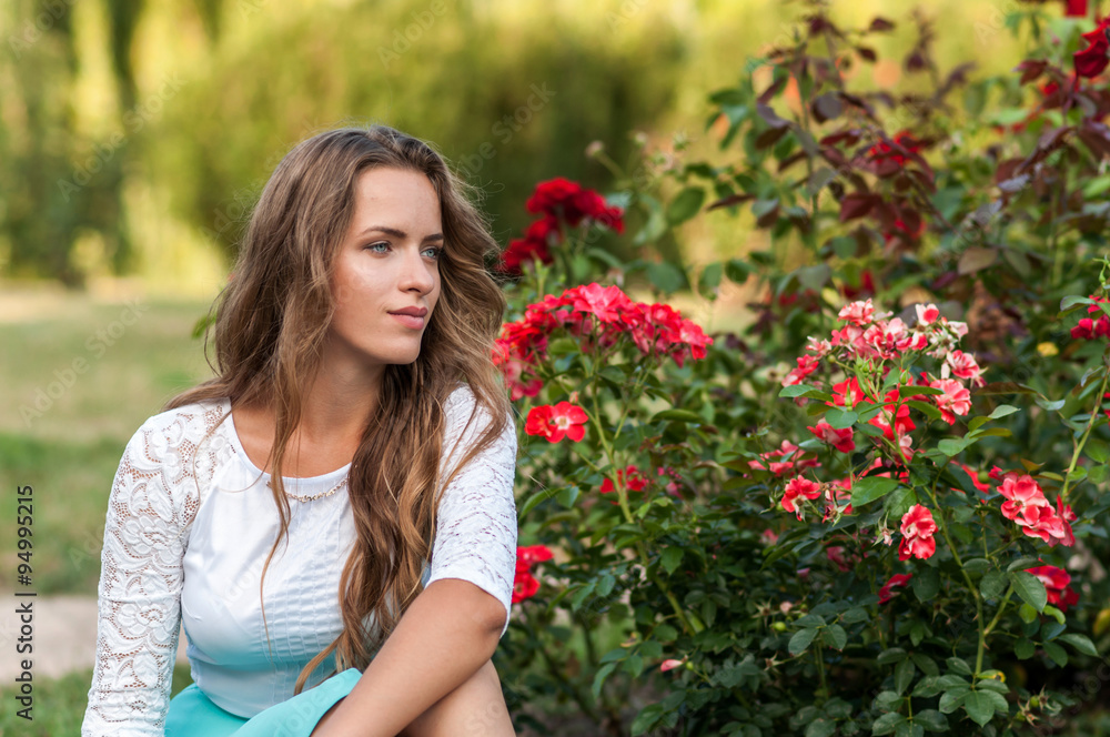 long-haired teen girl is sitting on flowers meadow long-haired teen girl is sitting on flowers meadow