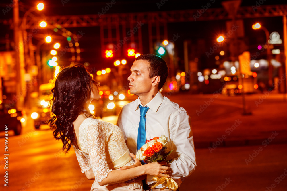 Obraz premium Elegant dressed man is tenderly embracing happy smiling woman