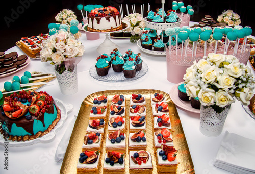 Delicious sweet holiday buffet with cupcakes, meringues and other desserts