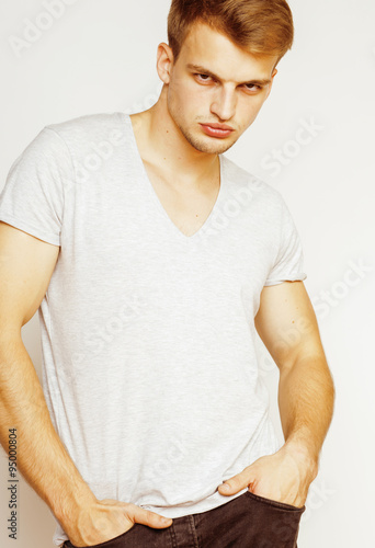 Canvas Print young handsome man on white background gesturing, pointing, posing emotional, cu