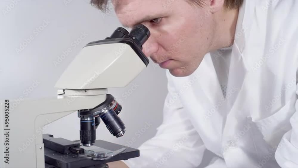 CLOSE UP: Doctor looking into the microscope CLOSE UP: Doctor looking into the microscope