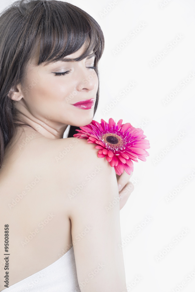 Beauty portrait of a brunette woman with a flower 