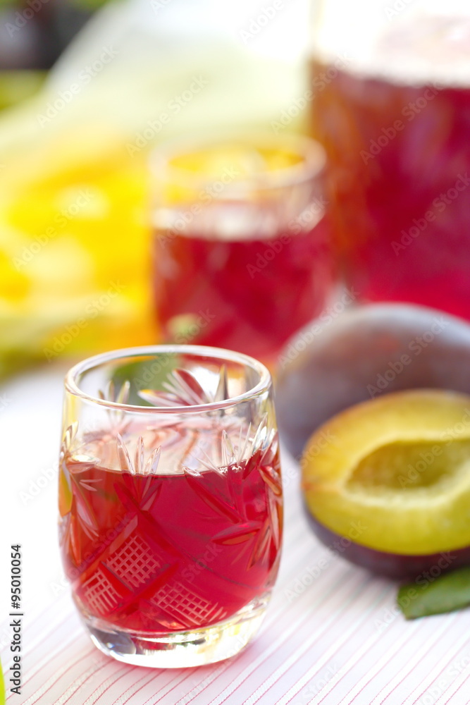 Glasses of plum alcohol with fresh plums Glasses of plum alcohol with fresh plums