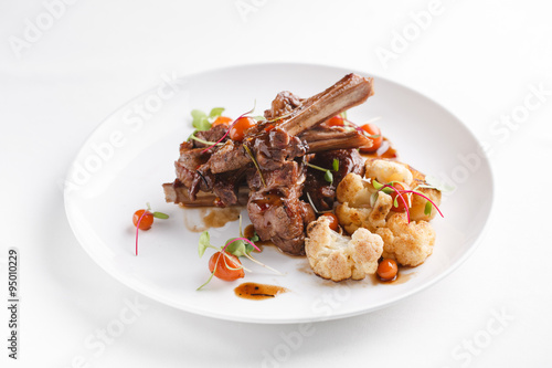 Grilled rack of lamb with vegetables.