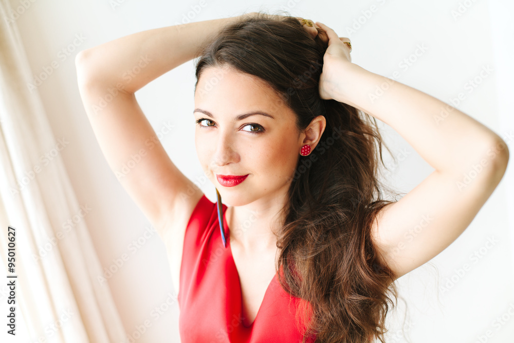 Fototapeta premium portrait of a young beautiful women in red dress with brunette h