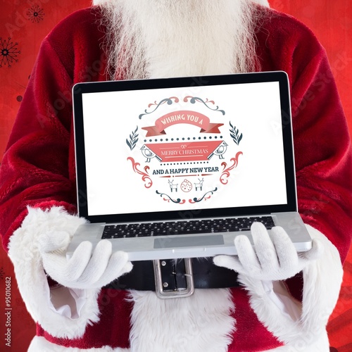 Composite image of santa claus presents a laptop photo