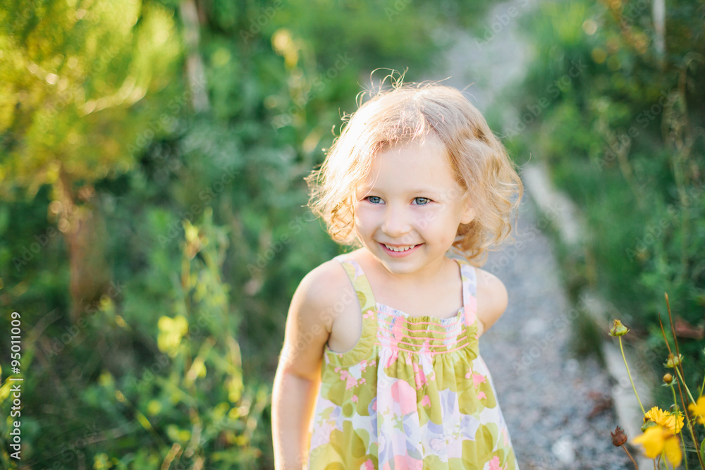 Portrait of a little girl walking in the garden Portrait of a little girl walking in the garden