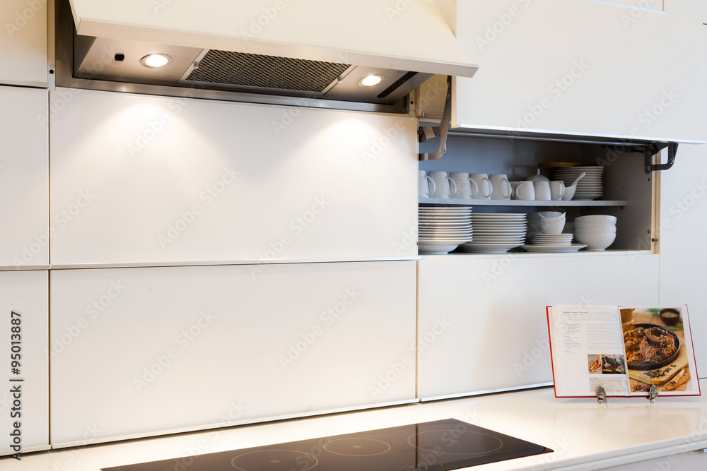 New modern white kitchen with open recipe book New modern white kitchen with open recipe book