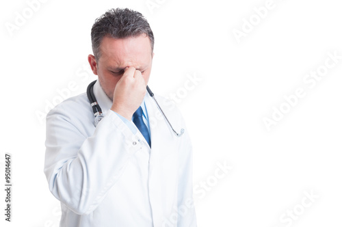 Stressed doctor or medic suffering a migraine © Catalin Pop