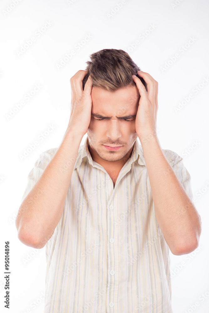 Naklejka premium Handsome young man touching his head feeling headache