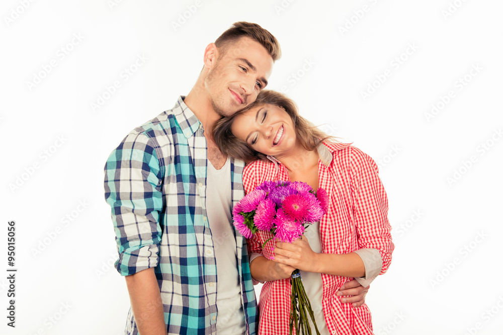Handsome young man giving a bouquet to his cute beloved Handsome young man giving a bouquet to his cute beloved
