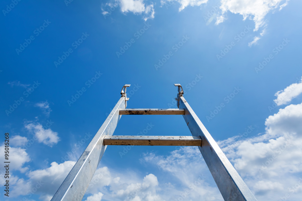 Ladder reaching into a blue sky and clouds Ladder reaching into a blue sky and clouds
