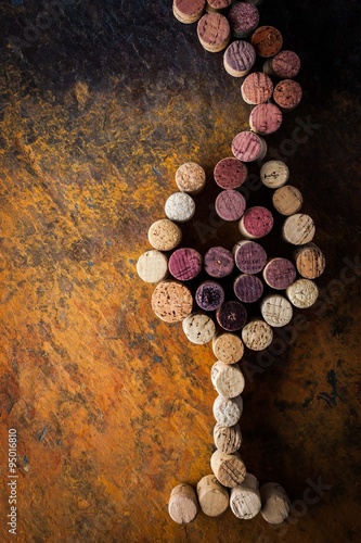 Glass of wine made by cork on the colorful background photo